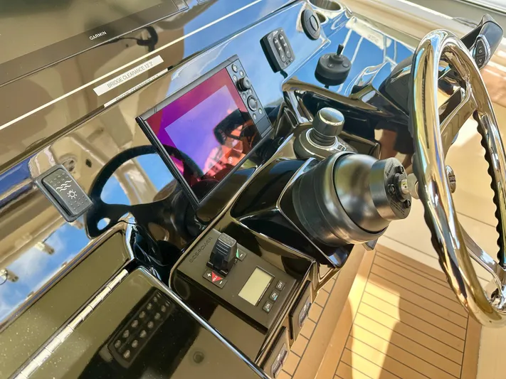  Yacht Photos Pics Control panel of 2019 Scout 380 LXF boat with steering wheel and navigation equipment.