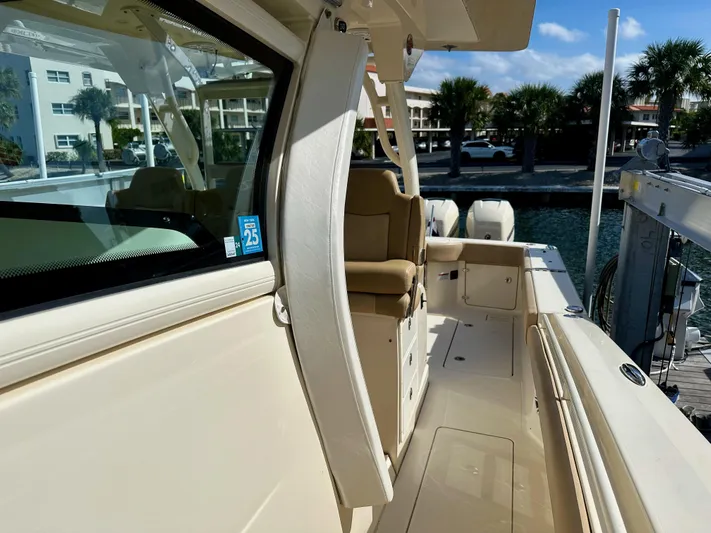  Yacht Photos Pics 2019 Scout 380 LXF boat docked, showcasing sleek design and luxurious seating.