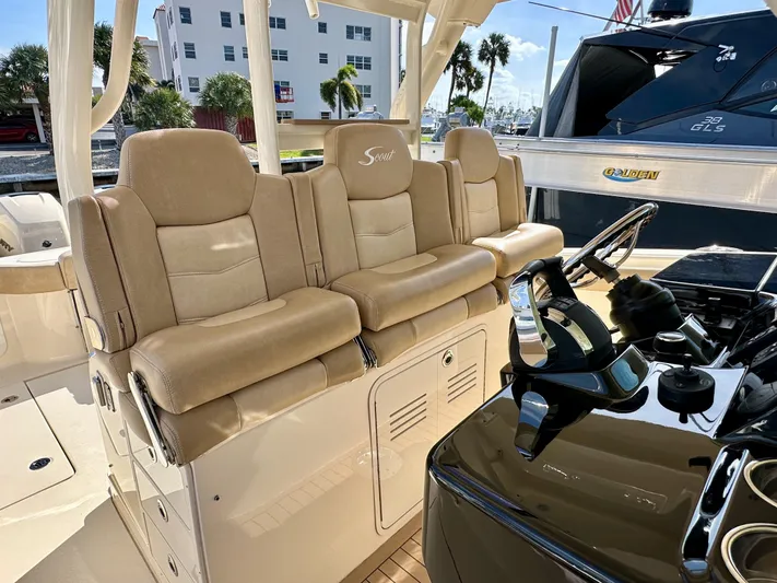  Yacht Photos Pics 2019 Scout 380 LXF boat interior with beige seating and modern helm controls.
