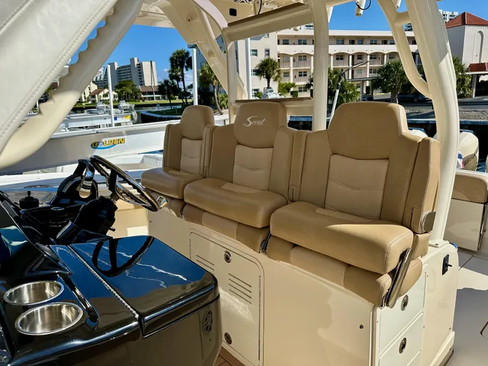  Yacht Photos Pics 2019 Scout 380 LXF boat interior with beige seating and steering console.