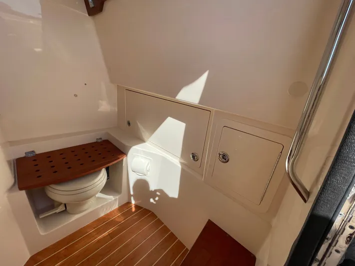  Yacht Photos Pics Interior of 2023 Grady-White Canyon 326 with toilet and wood accents.