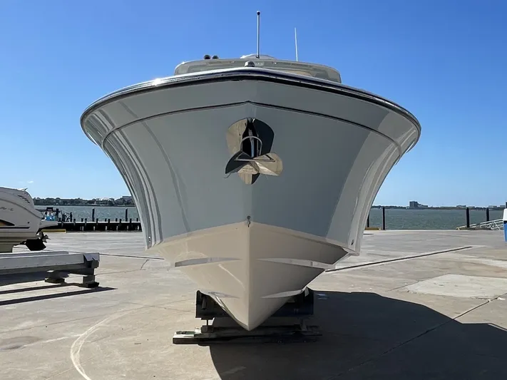  Yacht Photos Pics Grady-White Canyon 326 boat, 2023 model, on a dock under sunny skies.