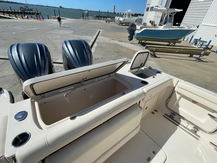  Yacht Photos Pics Grady-White Canyon 326 boat, 2023 model, at dock with open storage compartment.