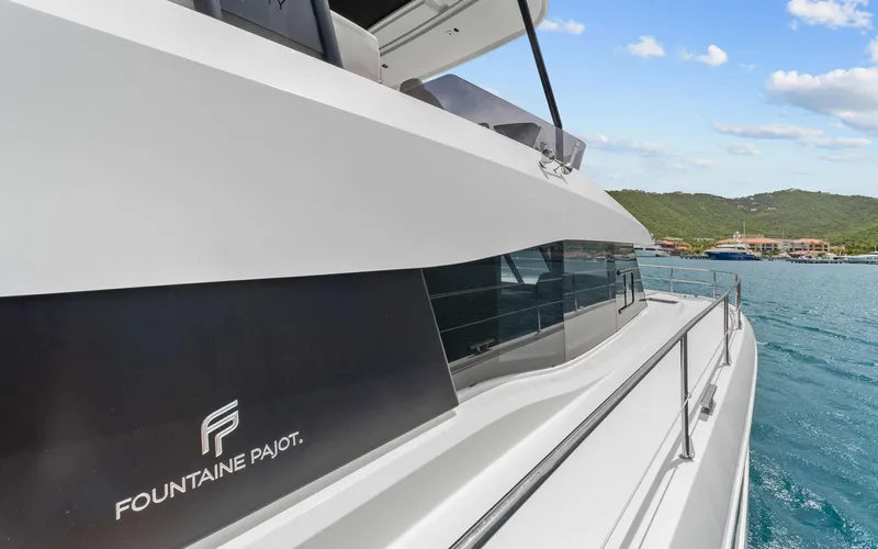 Mona Lisa Yacht Photos Pics 2024 Fountaine Pajot MY.6 yacht on serene blue waters, showcasing sleek design.