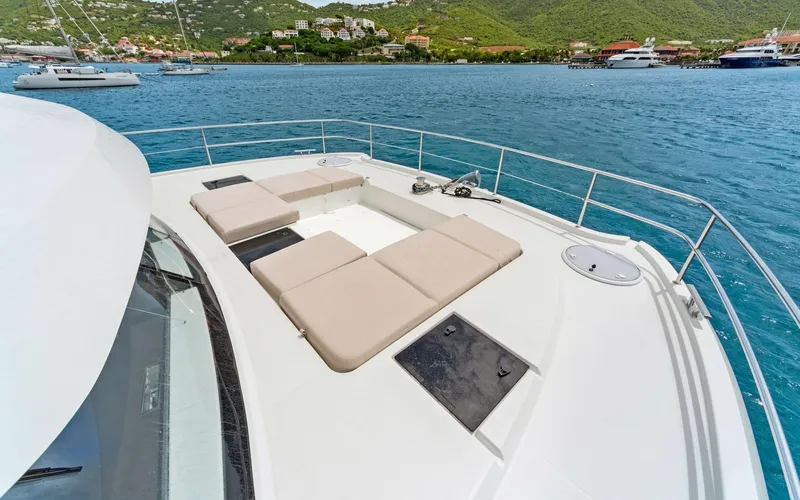 Mona Lisa Yacht Photos Pics 2024 Fountaine Pajot MY.6 yacht deck with sun loungers, overlooking scenic coastal view.