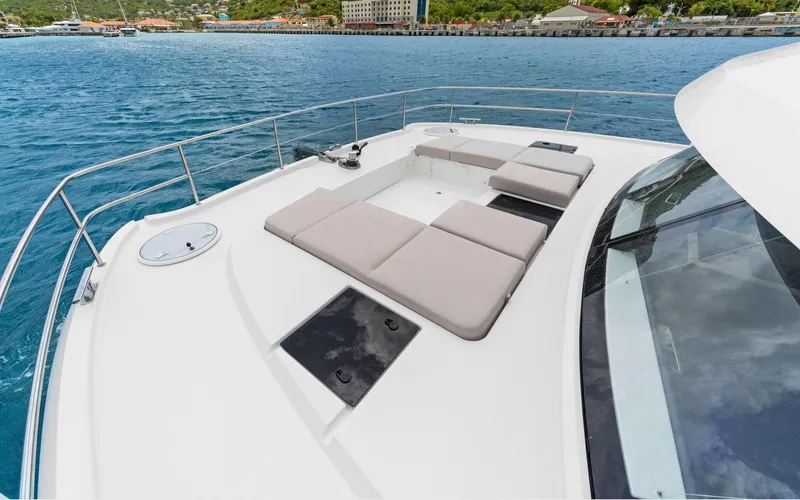 Mona Lisa Yacht Photos Pics 2024 Fountaine Pajot MY.6 yacht deck with sun loungers on calm blue water.