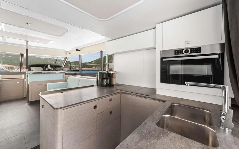 Mona Lisa Yacht Photos Pics Modern kitchen interior of 2024 Fountaine Pajot MY.6 yacht with sleek design and appliances.