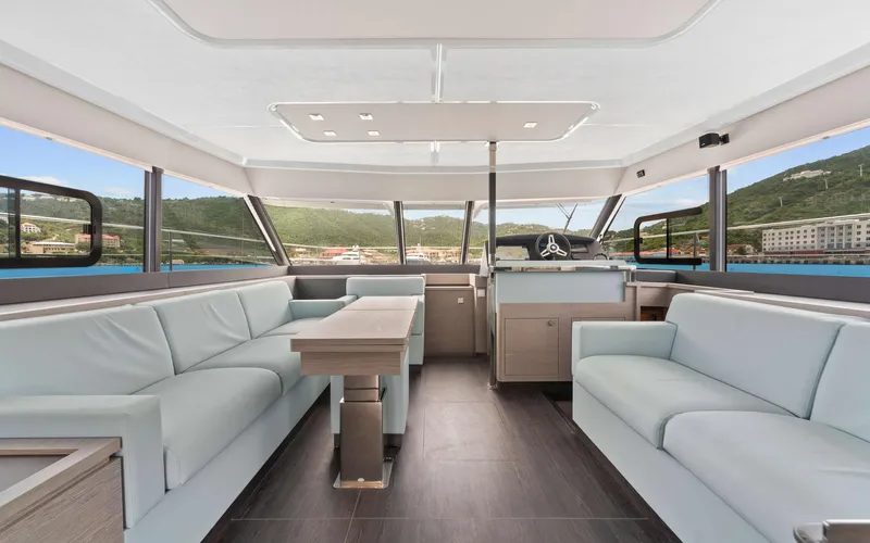 Mona Lisa Yacht Photos Pics Luxurious interior of 2024 Fountaine Pajot MY.6 yacht with modern seating and panoramic windows.