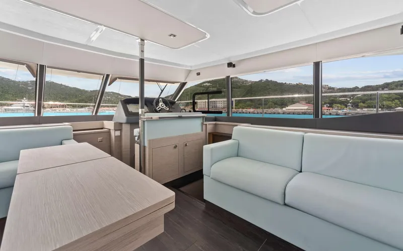 Mona Lisa Yacht Photos Pics Luxurious interior of 2024 Fountaine Pajot MY.6 yacht with modern seating and panoramic windows.