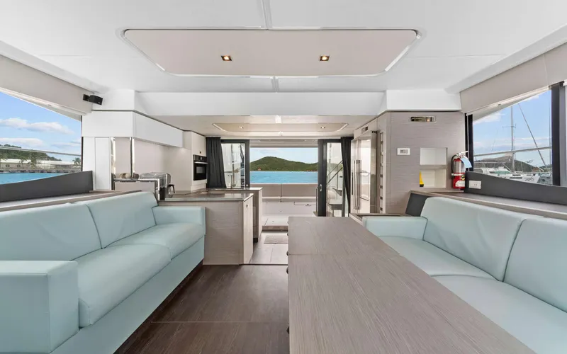 Mona Lisa Yacht Photos Pics Luxurious interior of 2024 Fountaine Pajot MY.6 yacht with modern seating and ocean view.