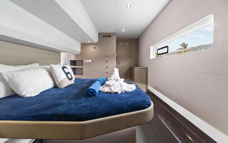 Mona Lisa Yacht Photos Pics Luxurious bedroom interior of 2024 Fountaine Pajot MY.6 yacht with modern design and ocean view.