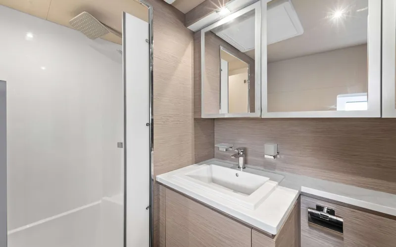 Mona Lisa Yacht Photos Pics Modern bathroom interior on 2024 Fountaine Pajot MY.6 yacht, featuring sleek sink and shower.