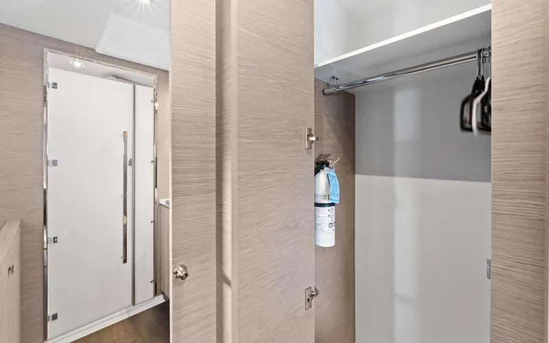 Mona Lisa Yacht Photos Pics 2024 Fountaine Pajot MY.6 yacht interior closet with fire extinguisher and hangers.