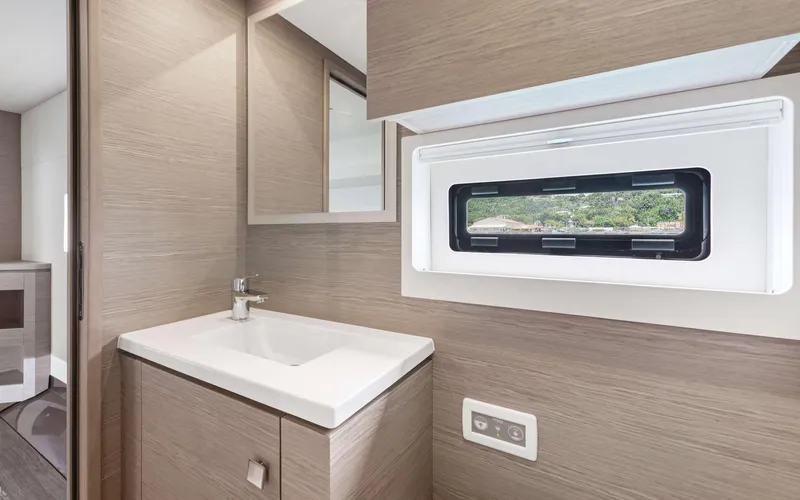 Mona Lisa Yacht Photos Pics Modern bathroom interior of 2024 Fountaine Pajot MY.6 yacht with sleek sink and window.