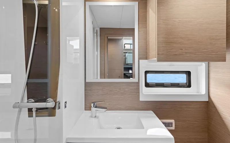 Mona Lisa Yacht Photos Pics Modern bathroom interior of 2024 Fountaine Pajot MY.6 yacht with sleek fixtures.