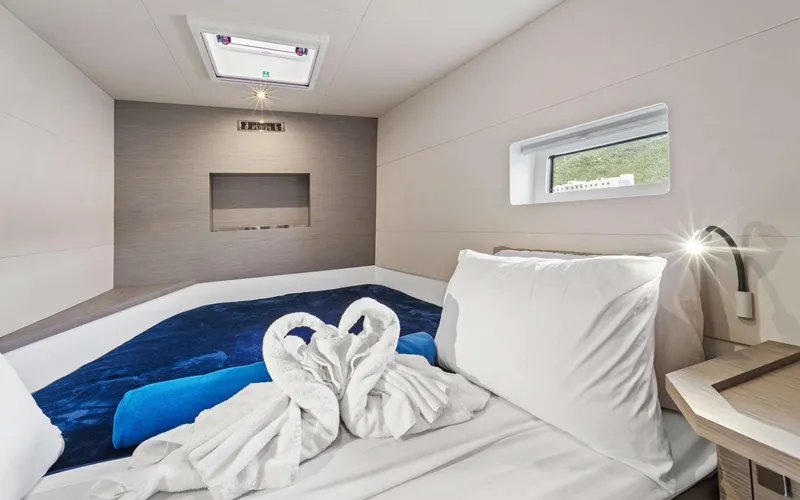 Mona Lisa Yacht Photos Pics Luxurious cabin interior of 2024 Fountaine Pajot MY.6 with elegant bedding and decor.