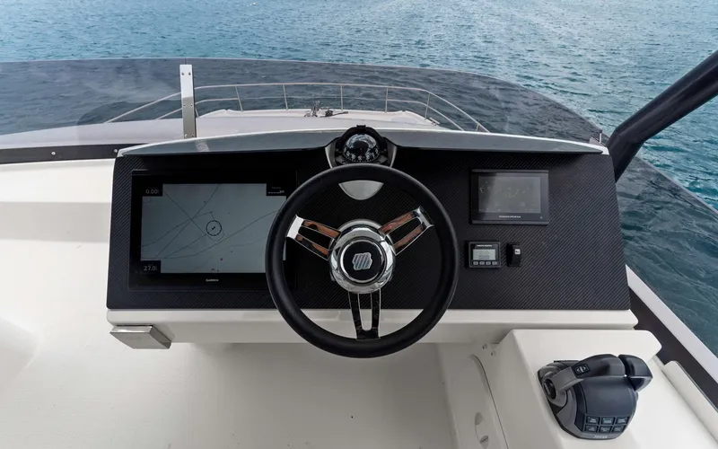Mona Lisa Yacht Photos Pics 2024 Fountaine Pajot MY.6 helm with navigation screens and steering wheel, overlooking the ocean.