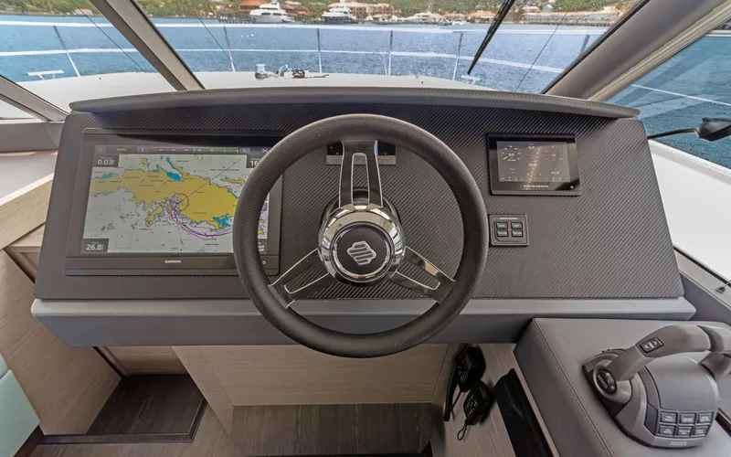 Mona Lisa Yacht Photos Pics 2024 Fountaine Pajot MY.6 helm with navigation screens and steering wheel.