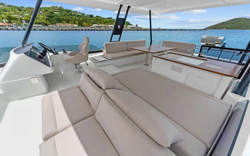 Mona Lisa Yacht Photos Pics Luxurious 2024 Fountaine Pajot MY.6 yacht interior with spacious seating and scenic ocean view.