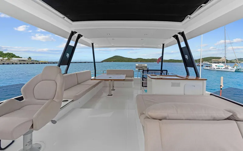 Mona Lisa Yacht Photos Pics Luxurious 2024 Fountaine Pajot MY.6 yacht interior with spacious seating and scenic ocean view.