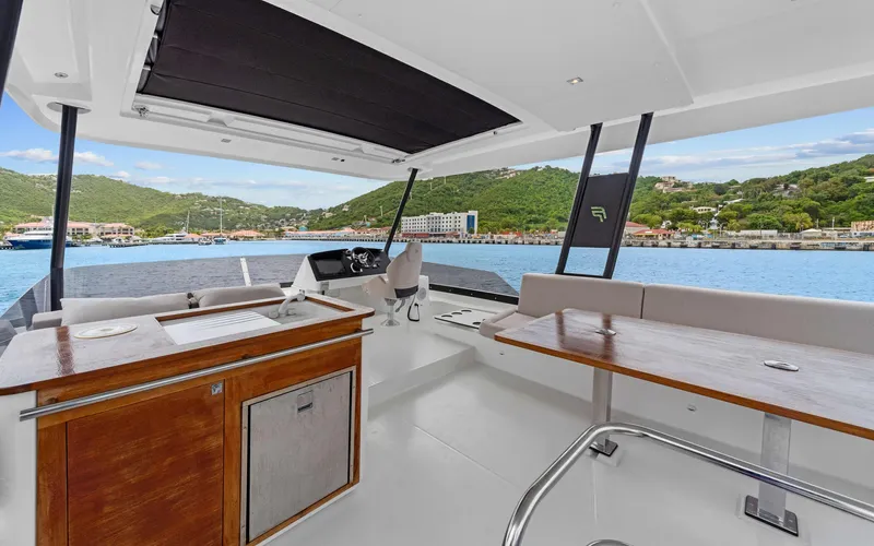 Mona Lisa Yacht Photos Pics 2024 Fountaine Pajot MY.6 yacht interior with scenic ocean and hillside view.