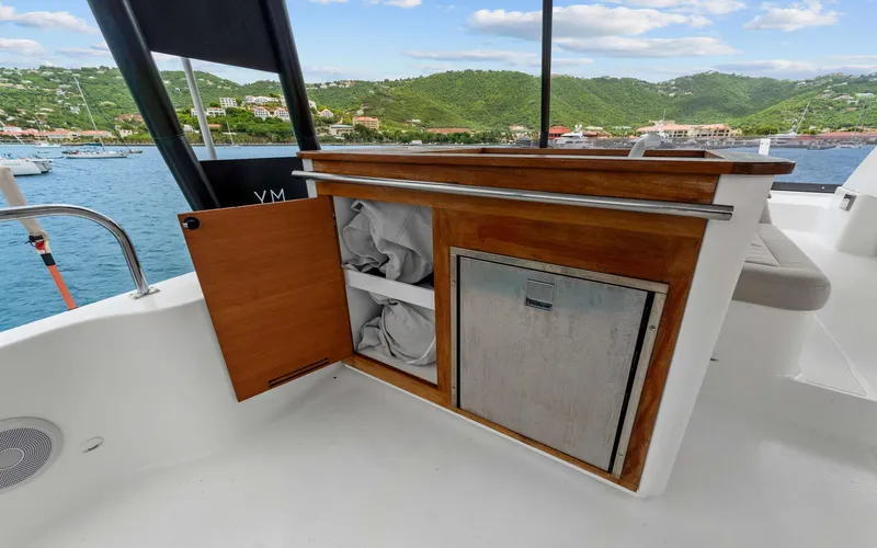 Mona Lisa Yacht Photos Pics 2024 Fountaine Pajot MY.6 yacht interior with wooden storage cabinet and scenic ocean view.