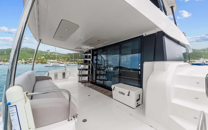 Mona Lisa Yacht Photos Pics 2024 Fountaine Pajot MY.6 yacht deck with seating, stairs, and ocean view.