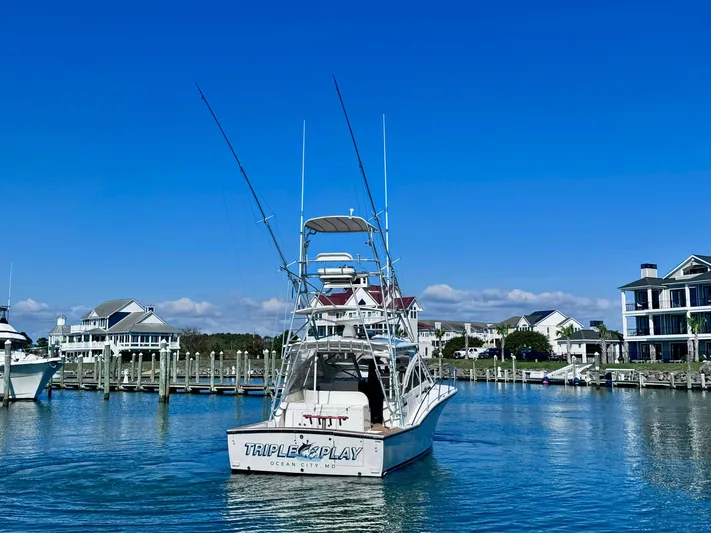 Triple Play Yacht Photos Pics 2005 Carolina Classic 35 boat docked in a marina under clear blue skies.