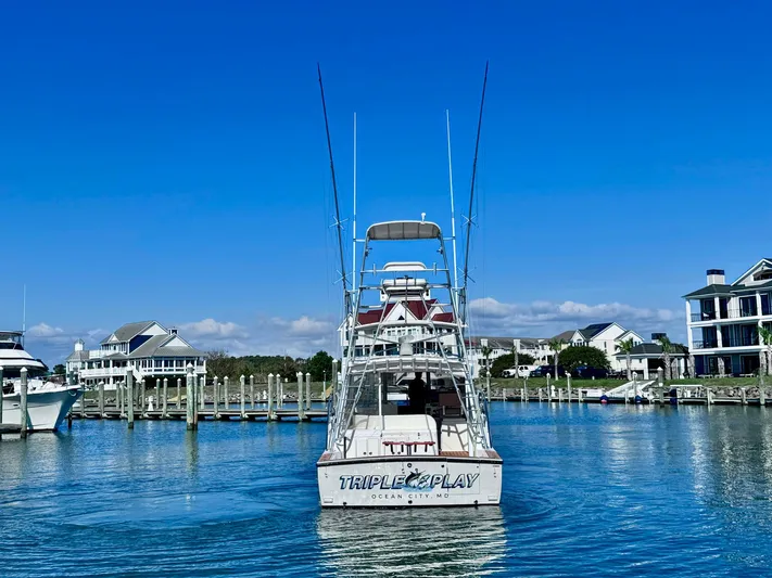 Triple Play Yacht Photos Pics 2005 Carolina Classic 35 boat docked in a scenic marina.