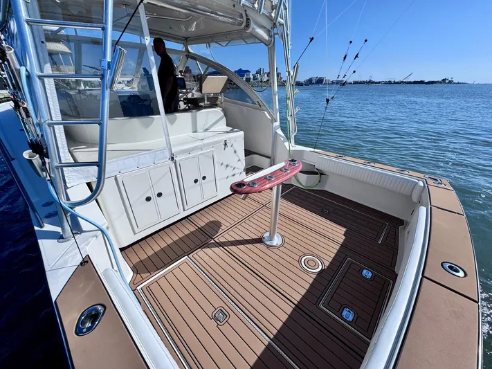 Triple Play Yacht Photos Pics 2005 Carolina Classic 35 boat with spacious deck and fishing setup on calm waters.