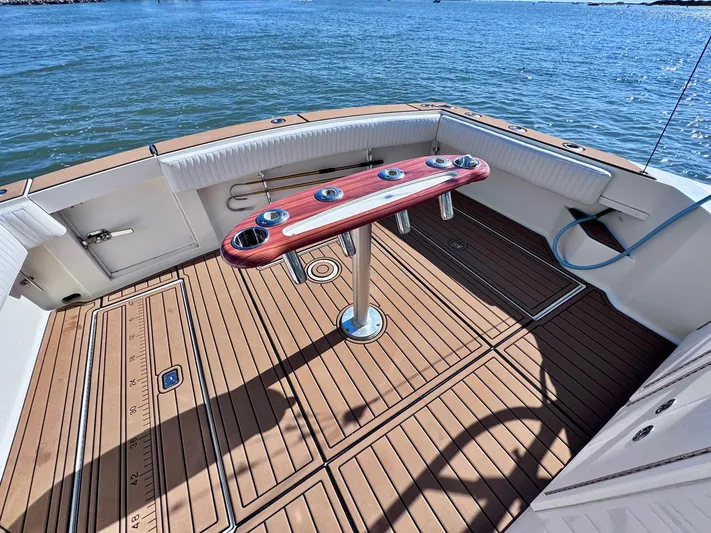 Triple Play Yacht Photos Pics 2005 Carolina Classic 35 boat deck with rod holders, teak flooring, and ocean view.