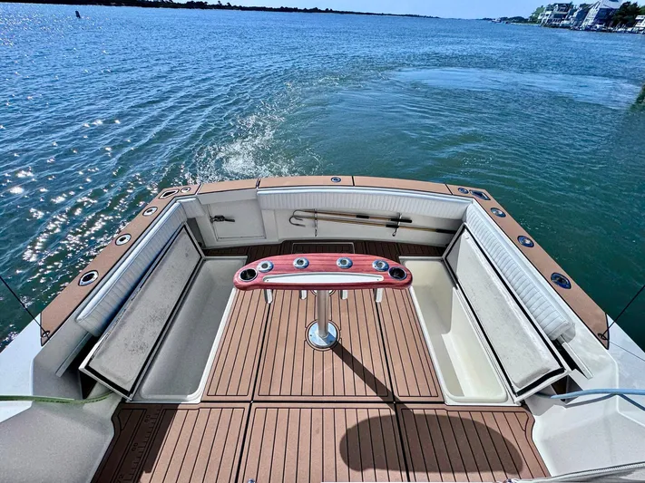 Triple Play Yacht Photos Pics 2005 Carolina Classic 35 boat deck with ocean view and fishing rod holders.