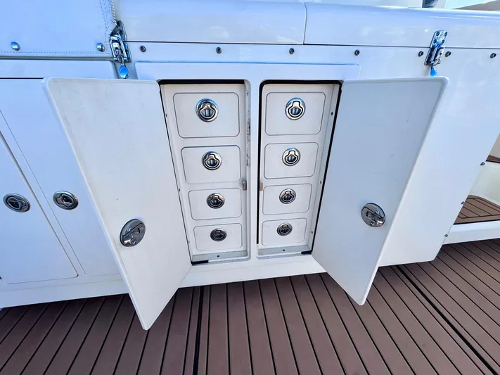 Triple Play Yacht Photos Pics 2005 Carolina Classic 35 boat storage compartments with open doors and multiple drawers.