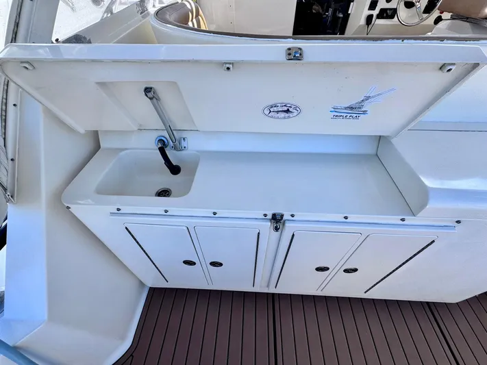 Triple Play Yacht Photos Pics 2005 Carolina Classic 35 boat sink and storage area with wooden deck.