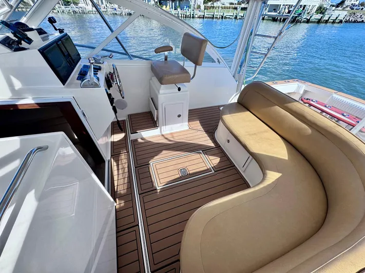 Triple Play Yacht Photos Pics 2005 Carolina Classic 35 boat interior with tan seating and wood flooring.
