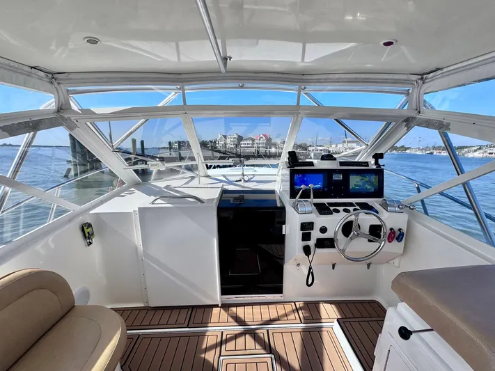 Triple Play Yacht Photos Pics 2005 Carolina Classic 35 boat interior with helm, steering wheel, and navigation screens.