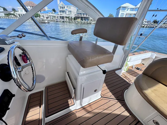 Triple Play Yacht Photos Pics 2005 Carolina Classic 35 boat interior with helm seat and wooden deck.