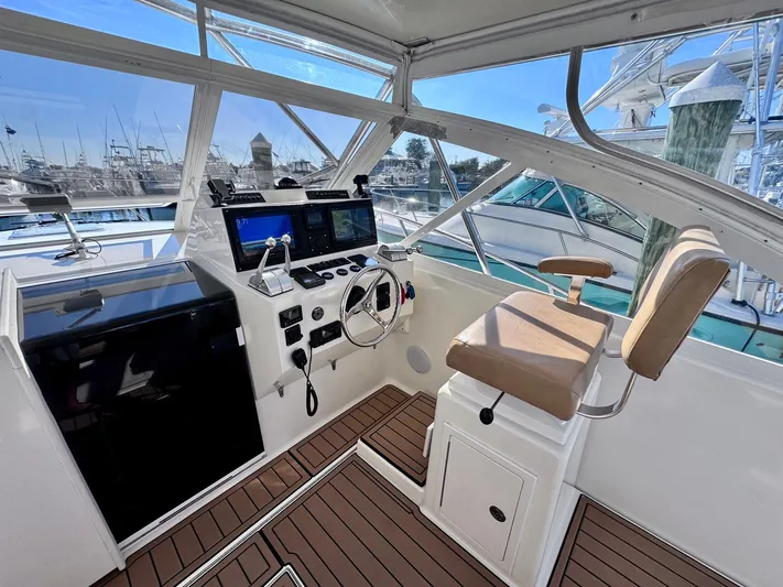 Triple Play Yacht Photos Pics 2005 Carolina Classic 35 boat helm with modern controls and seating at marina.