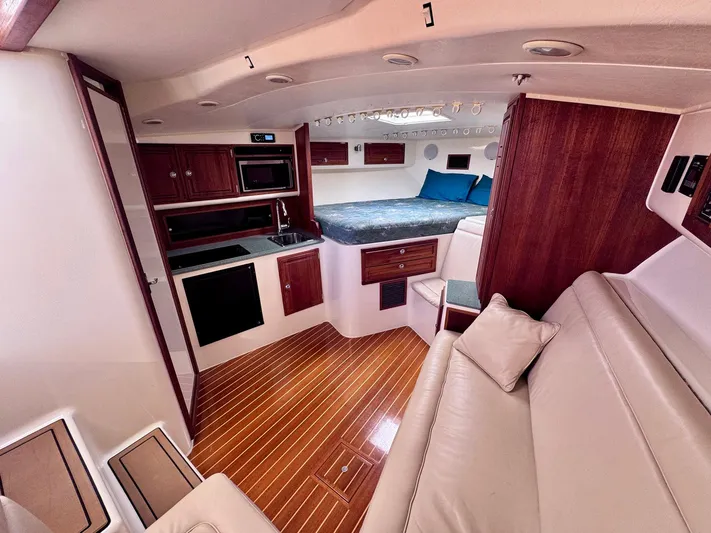 Triple Play Yacht Photos Pics Luxurious interior of 2005 Carolina Classic 35 boat with kitchen and sleeping area.