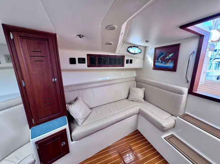 Triple Play Yacht Photos Pics Interior of 2005 Carolina Classic 35 boat with beige seating and wooden accents.