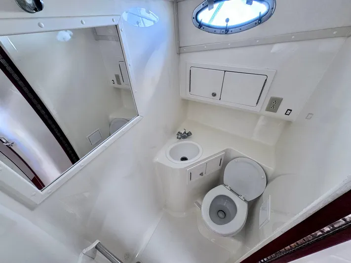 Triple Play Yacht Photos Pics 2005 Carolina Classic 35 boat bathroom with sink, toilet, and storage cabinets.