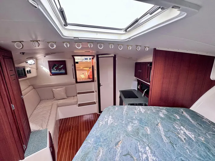 Triple Play Yacht Photos Pics Interior of 2005 Carolina Classic 35 boat with cozy seating and wood accents.
