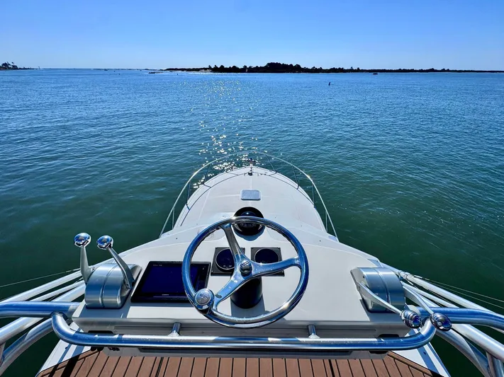 Triple Play Yacht Photos Pics Carolina Classic 35 boat helm, 2005 model, overlooking serene ocean waters.