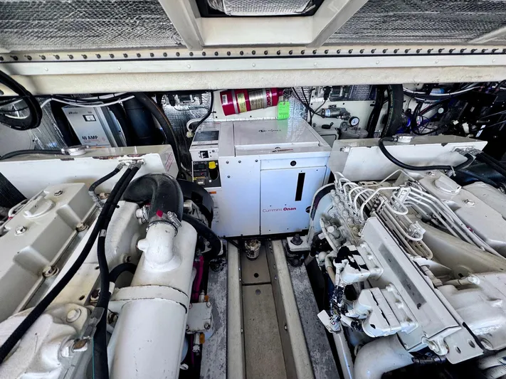 Triple Play Yacht Photos Pics Engine room of a 2005 Carolina Classic 35 boat, featuring dual engines and equipment.