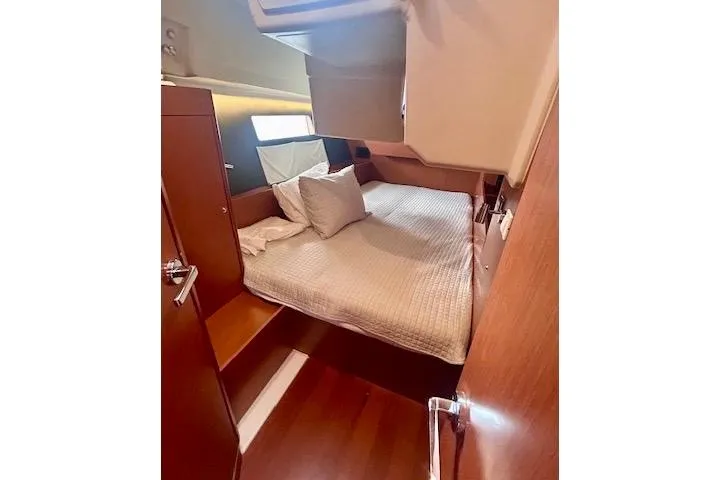  Yacht Photos Pics 2017 Beneteau Oceanis 41.1 cabin interior with cozy bed and wooden finish.