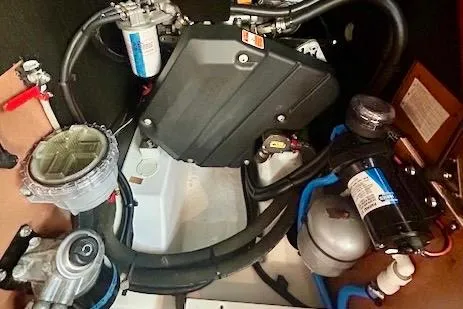  Yacht Photos Pics Engine compartment of 2017 Beneteau Oceanis 41.1 sailboat, showcasing mechanical components and hoses.