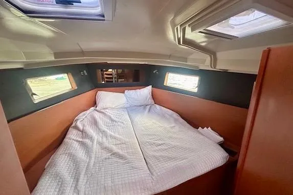  Yacht Photos Pics Cozy cabin interior of 2017 Beneteau Oceanis 41.1 sailboat with comfortable bedding.