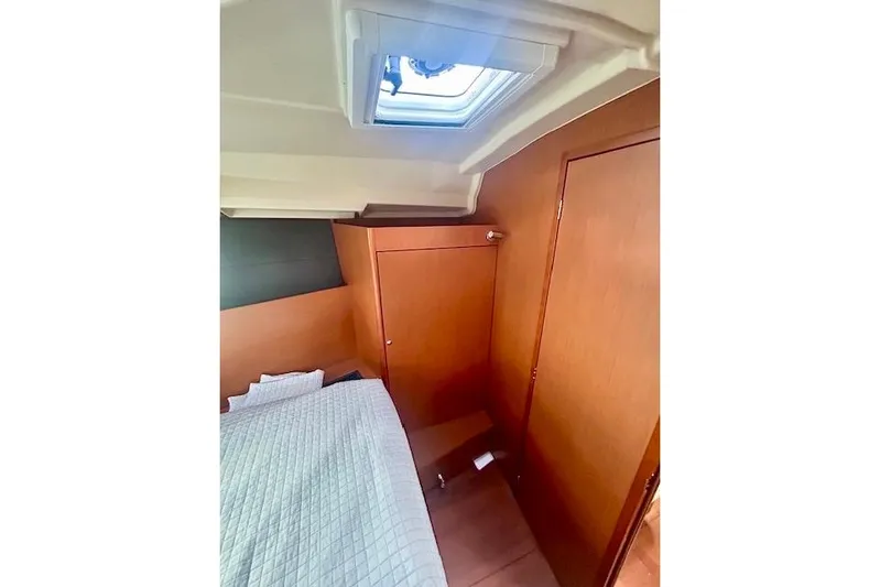  Yacht Photos Pics 2017 Beneteau Oceanis 41.1 cabin interior with bed and wooden paneling.