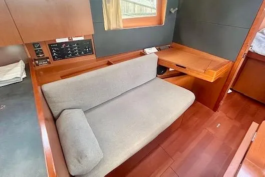  Yacht Photos Pics 2017 Beneteau Oceanis 41.1 interior with sofa and wooden furnishings.