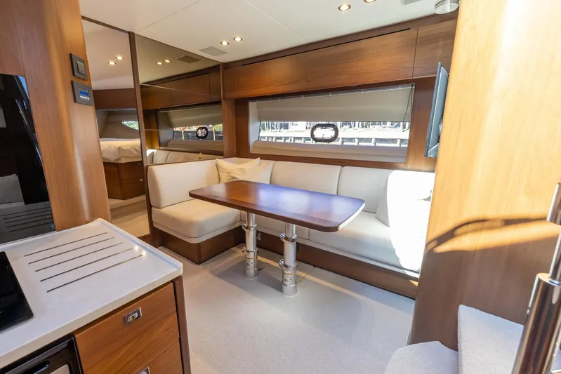 Quick Decision Yacht Photos Pics Interior of 2020 Princess V50 yacht with modern seating and dining area.